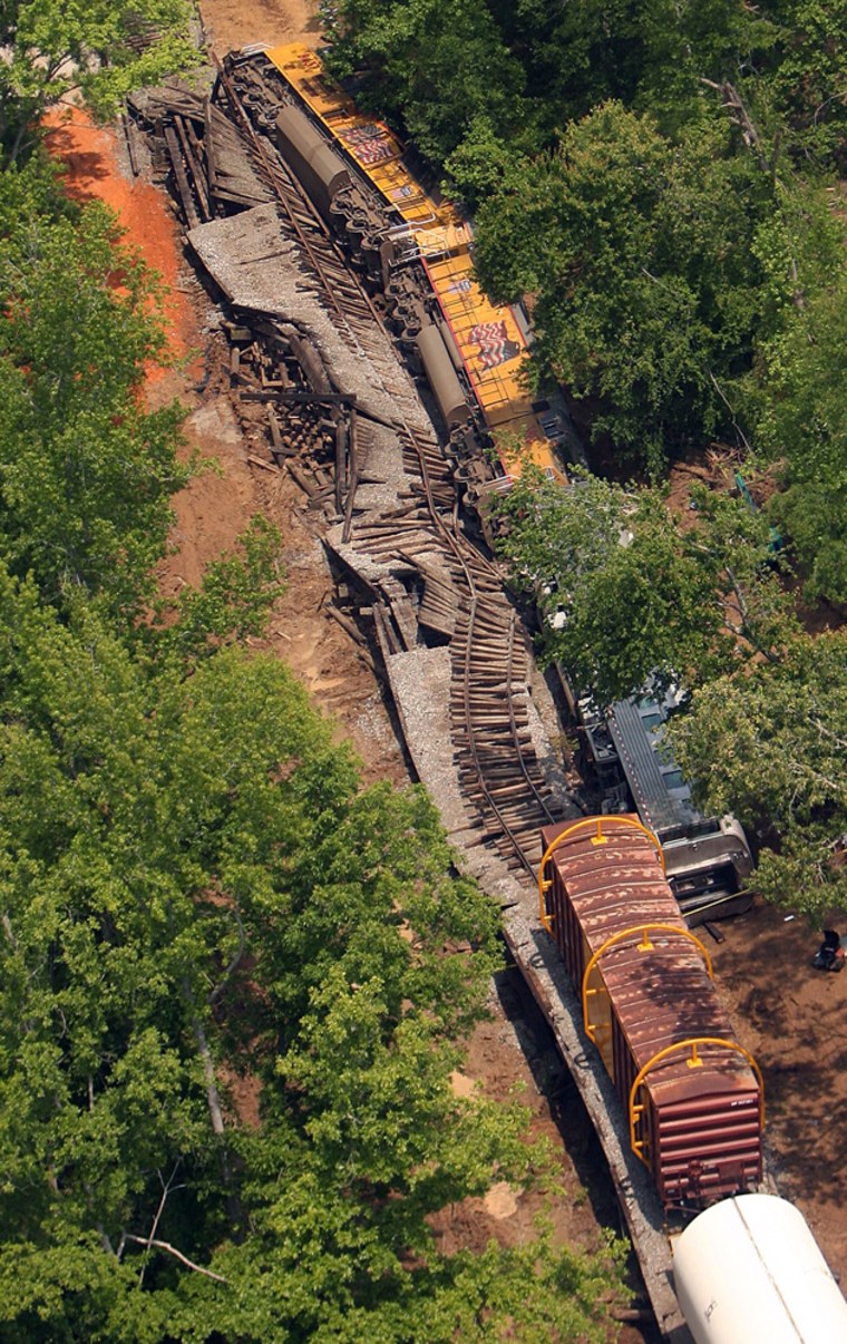 This aerial view shows a derailed freight train near Demopolis, Ala., on Wednesday. The train, carrying segments of the space shuttle's solid rocket boosters, derailed after a bridge collapsed, authorities said. Six people were reported injured.