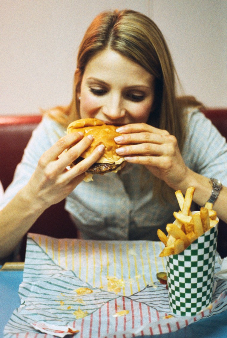 Woman Eating Fast Food Hamburger