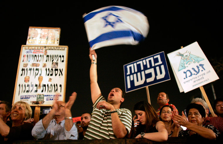 A demonstrator waves an Israeli flag as