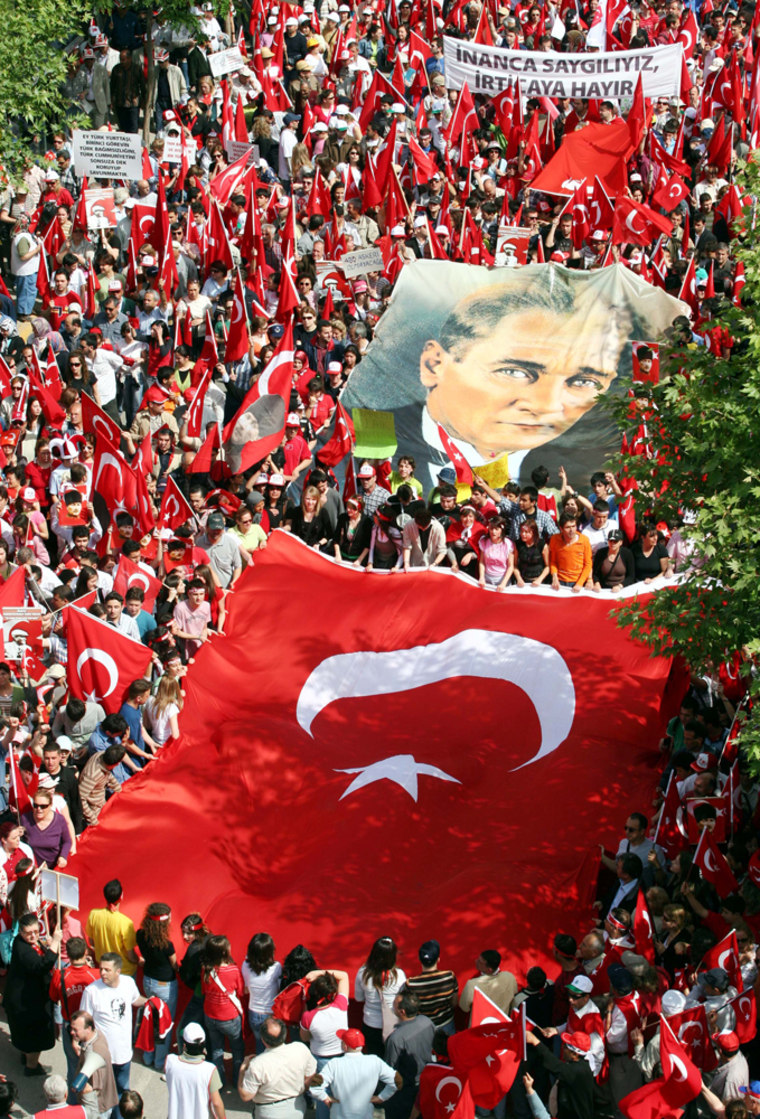 Demonstrators march with Turkish flags and a huge poster of modern Turkey's founder Ataturk during a pro-secular rally in Manisa, western Turkey, on Saturday.