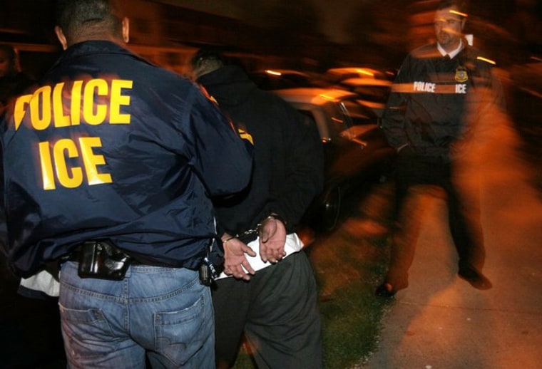 An Immigrations and Customs Enforcement agent handcuffs a Salvadoran fugitive in Alexandria, Va.