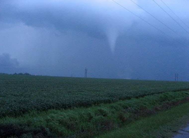 A twister descends from the clouds two miles southwest of Greensburg, Kan., Saturday night, one of 85 reported across the Plains.