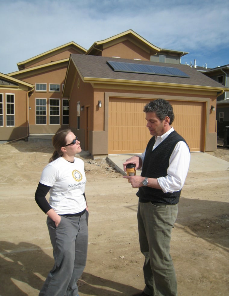 Harvard Communities President John Keith talks with Amanda Bybee, owner of solar installer Namaste Solar, about a solar installation planned for homes in Denver's Stapleton neighborhood.