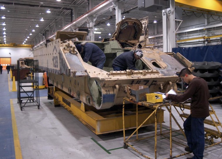 Workers inspect a Bradley vehicle in preparation for shipment from BAE Systems in Lemont Furnace, Pa., Fayette County, on Nov. 30, 2006. The company has seen business roughly double since the start of the Iraq war in 2003.