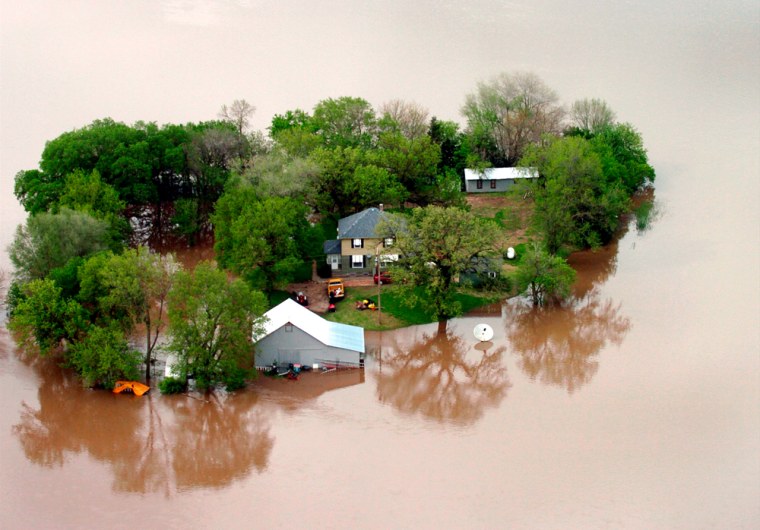 Floodwaters surround a farmstead near New Cambria, Kan. on Monday, May 7, 2007. (AP Photo/Salina Journal, Jeff Cooper)