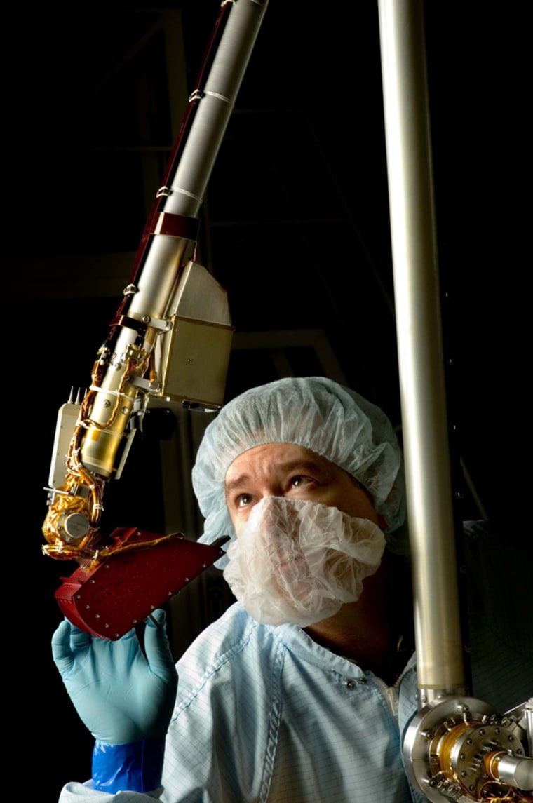 Spacecraft technician Billy Jones inspects the Mars Phoenix lander's robotic arm during assembly at a Lockheed Martin Space Systems clean-room facility near Denver. The lander was delivered to NASA's Kennedy Space Center this week, in preparation for its launch in August.