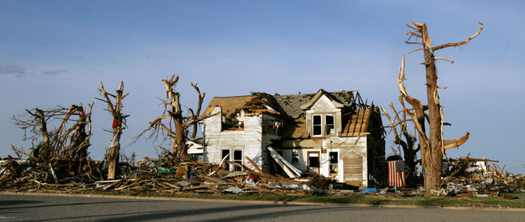 A tornado-damaged home stands amid rubble in Greensburg, Kan., on Monday.