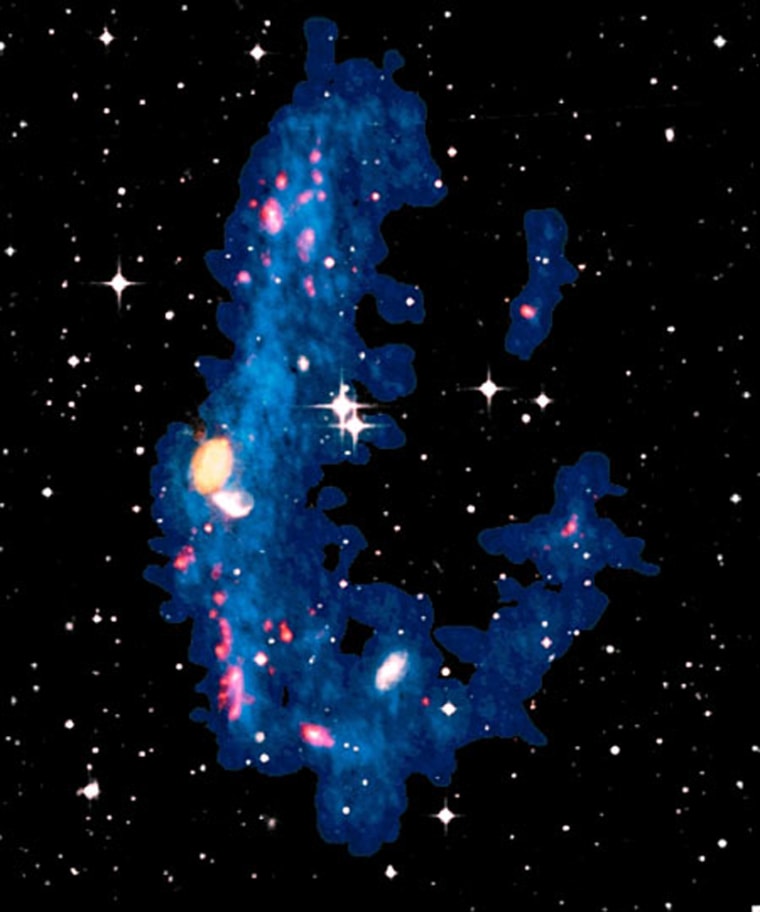This composite image shows the galaxy NGC5291 (orange, at the center) and its ring of debris (in blue), as seen by the Very Large Array interferometer. Researchers have found evidence for the presence of dark matter in dense star-forming groups (shown in red), where "recycled" dwarf galaxies exist.