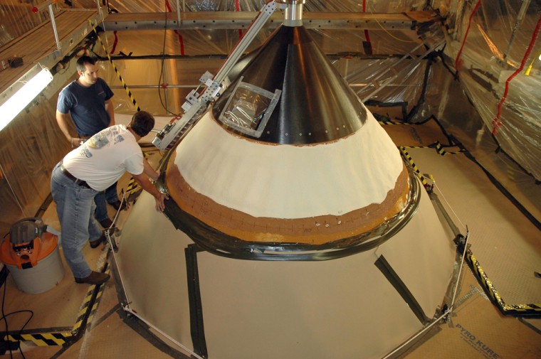 Technicians inspect the sanding performed on the shuttle Atlantis' nose cone to repair hail damage on Wednesday. The shuttle is being prepared in the Vehicle Assembly Building at NASA's Kennedy Space Center in Florida for a rollout to the launch pad as early as Tuesday.