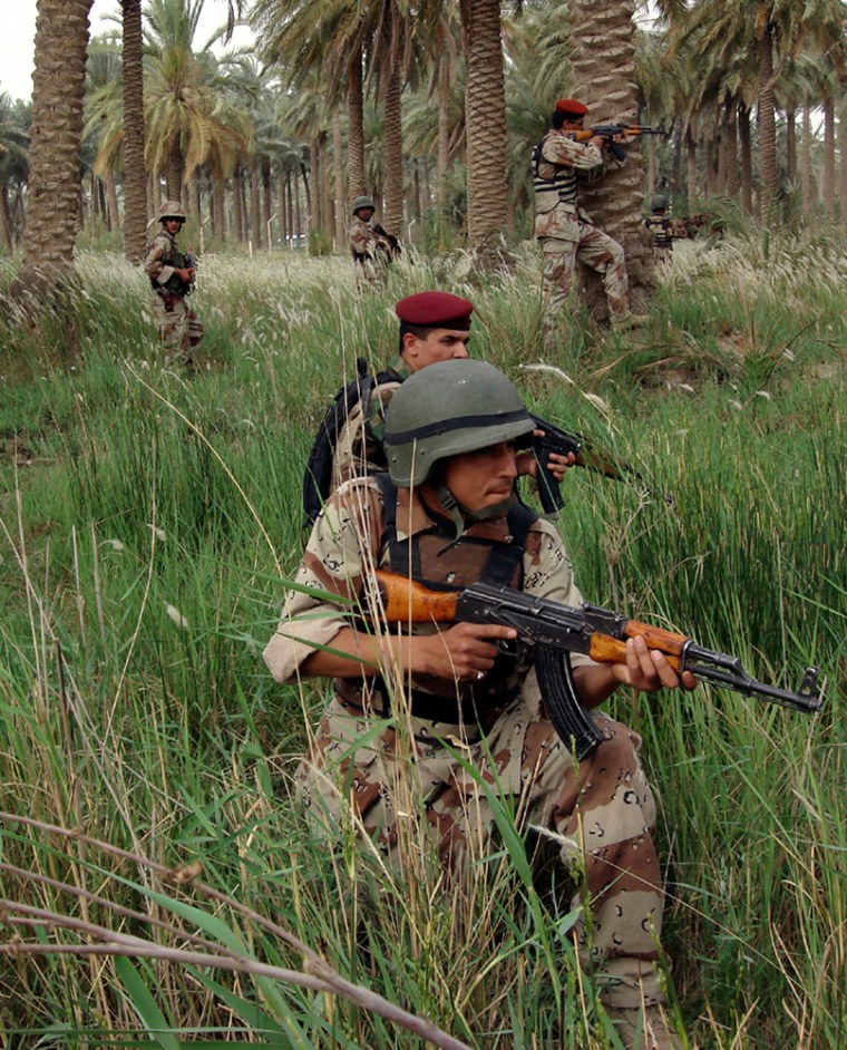 Iraqi soldiers take up positions while searching for three missing U.S. soldiers in the Shibaiya palm grove area