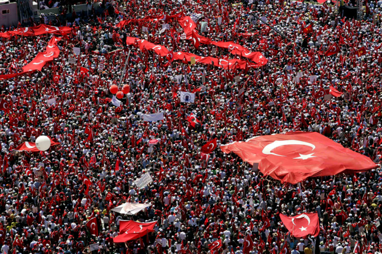 Demonstrators wave Turkish flags during a Sunday pro-secular rally in Izmir, Turkey. An estimated 1.5 million Turks demonstrated on the seafront of Turkey's third-largest city, fearful that the Islamic-rooted government is conspiring to impose religious values on society. The rally follows similar demonstrations in Ankara and Istanbul last month. 