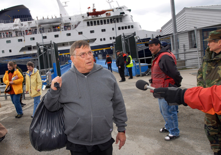 Issac Berman, of Jupiter, Florida, center, a passenger on the Empress of The North, is interviewed, in Juneau, Alaska Monday, May 14, 2007. The Empress of the North ran aground off the Alaska coast early Monday morning arrived in Juneau about ten hours later under Coast Guard escort. (AP Photo/Chris Miller)