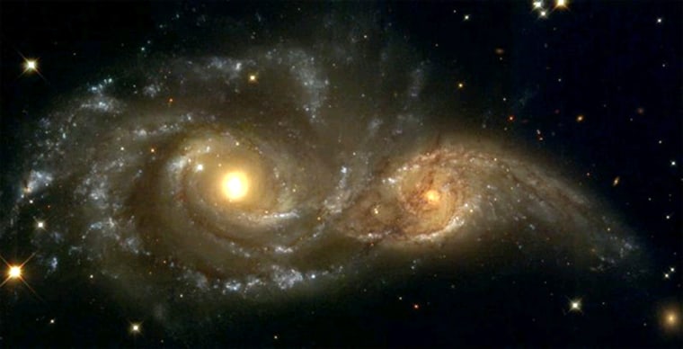 A near galactic-collision between NGC 2207 (left) and IC 2163 captured by the Hubble Space Telescope. Scientists predict the Milky Way will merge with its neighbor Andromeda in about 5 billion years. 