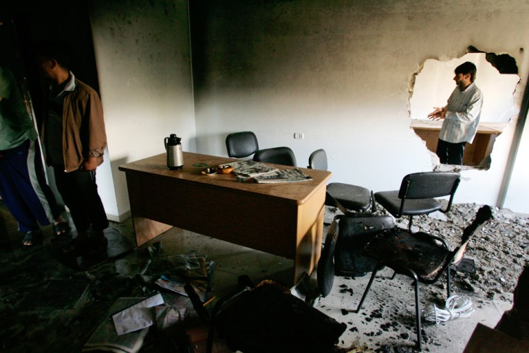 Palestinians inspect a burnt Fatah office after the clashes between Hamas and Fatah militants in Gaza