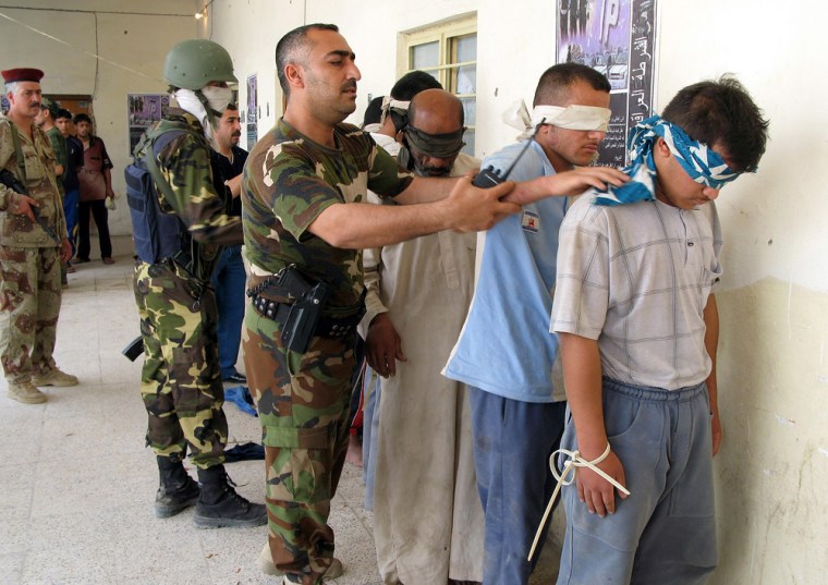 Iraqi soldiers detain suspected insurgents at a police station in Baqouba, 35 miles northeast of Baghdad, on May 10.