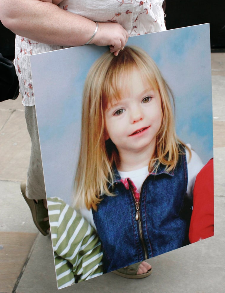 Aunt of missing British girl Madeleine McCann holds a photograph of Madeleine outside the Houses of Parliament in London