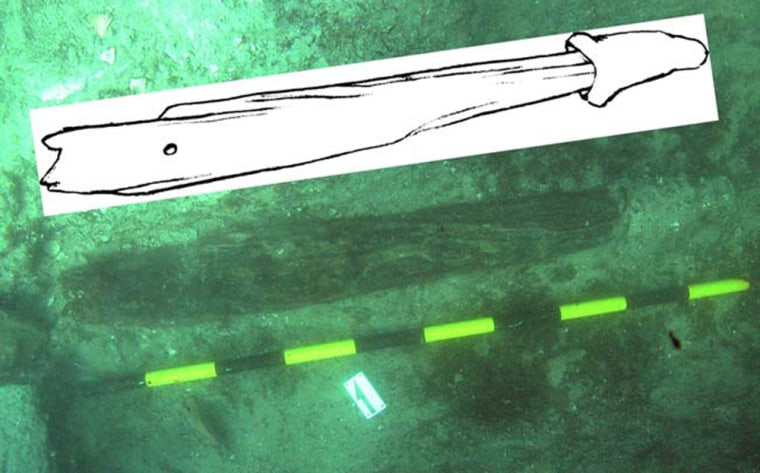 The oldest known wooden anchor, with an metal-covered crown, along with a drawing of what it would have looked like in the 7th century B.C. 