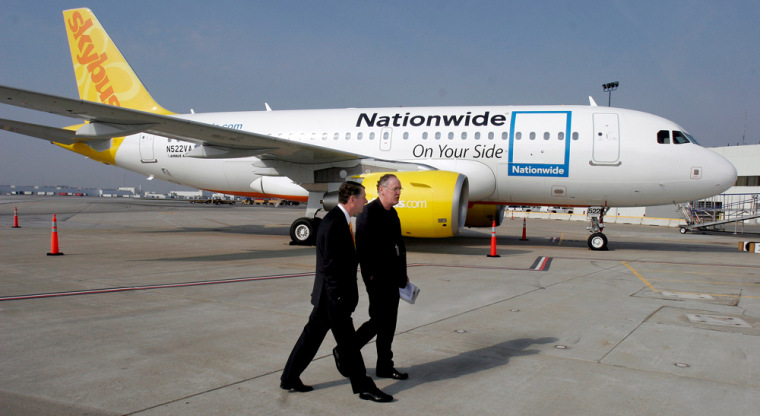 Nationwide Insurance CEO W.G. Jurgensen, left and Skybus CEO Bill Diffenderffer walk by a Skybus plane in this file photo. The airline is set to begin service Tuesday.