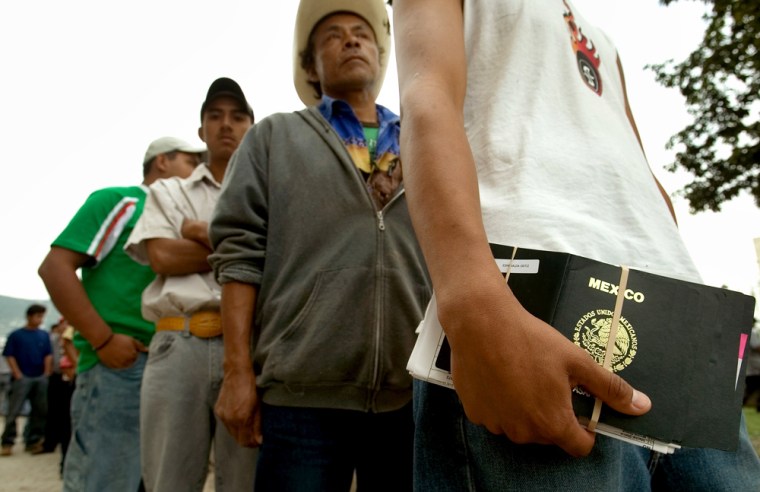 Mexicans line up outside the U.S. Consulate in Monterrey, Mexico, as they wait for a working visa interview, on Thursday.