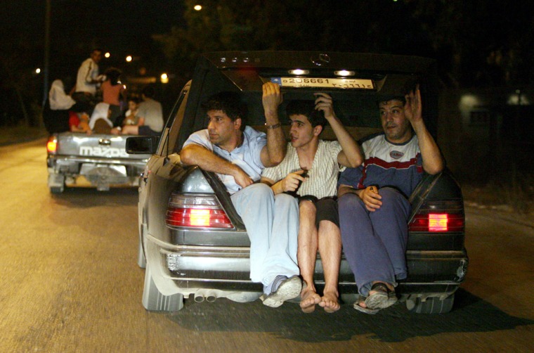 Palestinians flee the Palestinian refugee camp of Nahr el-Bared in the north city of Tripoli, Lebanon, Tuesday, May 22, 2007. Thousands of people fled from the area late Tuesday during a lull in the fighting in the third straight day of clashes between Lebanese troops and Islamic militants holed up in a north Lebanon refugee camp, Associated Press reporters at the scene said. (AP Photo/Nasser Nasser)