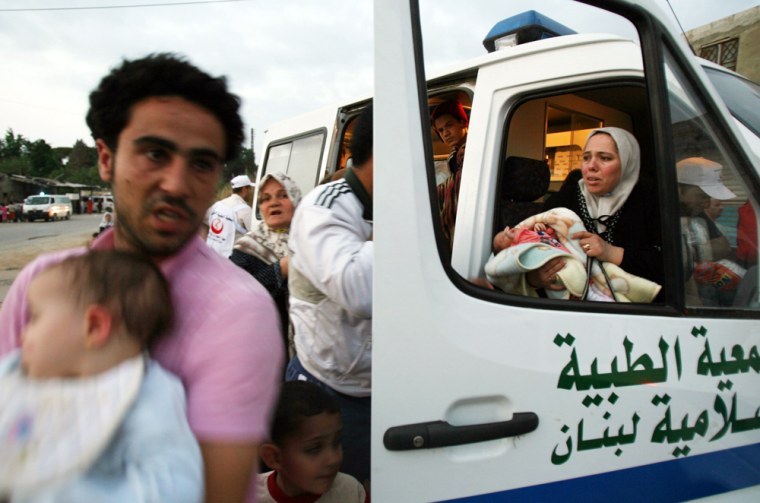 Palestinians are evacuated by ambulance as they flee the Nahr el-Bared refugee camp north of Tripoli, Lebanon, on Tuesday.