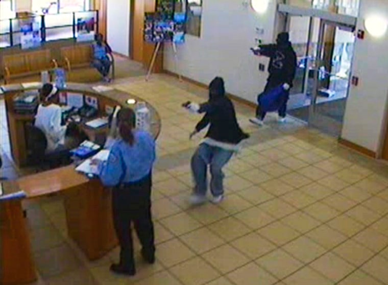 A surveillance photo released Wednesday by the FBI shows two of three masked gunmen inside the Illinois Service Federal Savings and Loan during a robbery on Tuesday, on Chicago's South Side. 