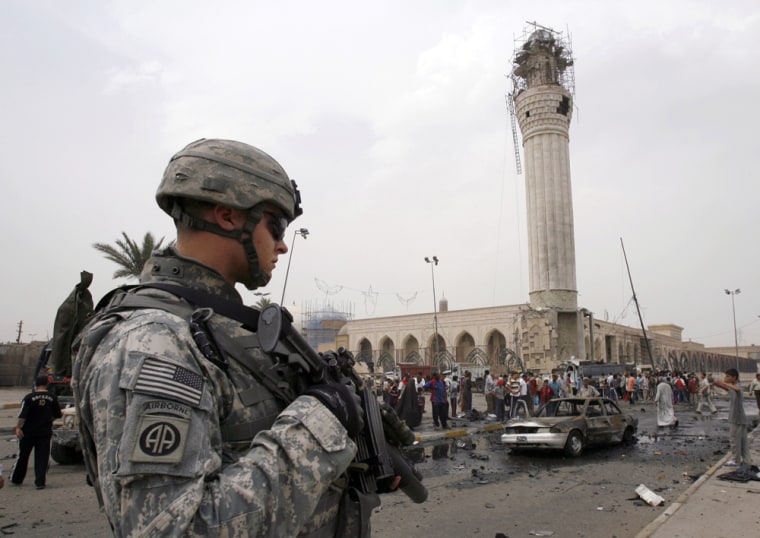 US soldier stands guard at site of bomb attack near a Sunni mosque in Baghdad