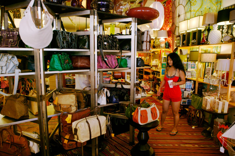 ** FOR IMMEDIATE RELEASE **A customer browses past a rack of handbags at the boutique, Into, May 13, 2007 in Honolulu.  Shedding a history filled with prostitution, gambling dens and streets plagued by drug dealers, Honolulu's Chinatown neighborhood once walked by the fictional detective Charlie Chan has finally begun to emerge from its dark past.  (AP Photo/Marco Garcia)