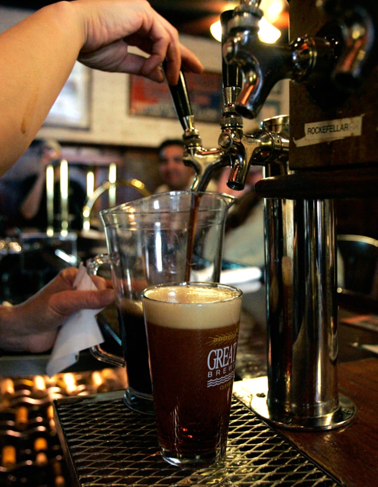 A bartender pours a pitcher of one of the many brews on tap at the Great Lakes Brewing Company in Cleveland, Ohio. Many beer aficionados are taking vacations which include visiting the nation's many local breweries, like Great Lakes Brewery, as well as brew pubs and beer festivals.