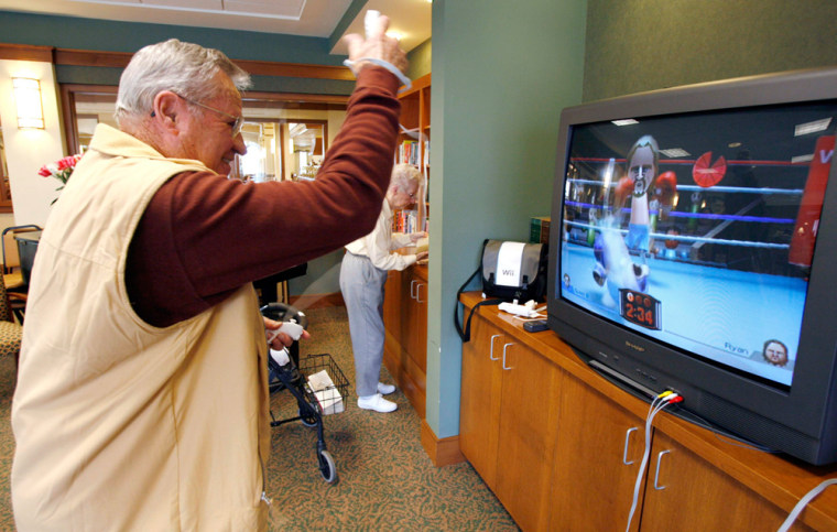 Resident of the Greenfield Retirement Community in Springfield, Virginia, plays boxing game on Wii game console