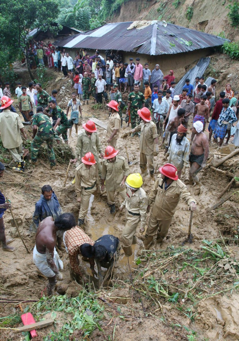 Several rescuers dig Tuesday for victims in Chittagong, Bangladesh, after mudslides wiped out a shantytown and hit other areas of this port city of 4 million.