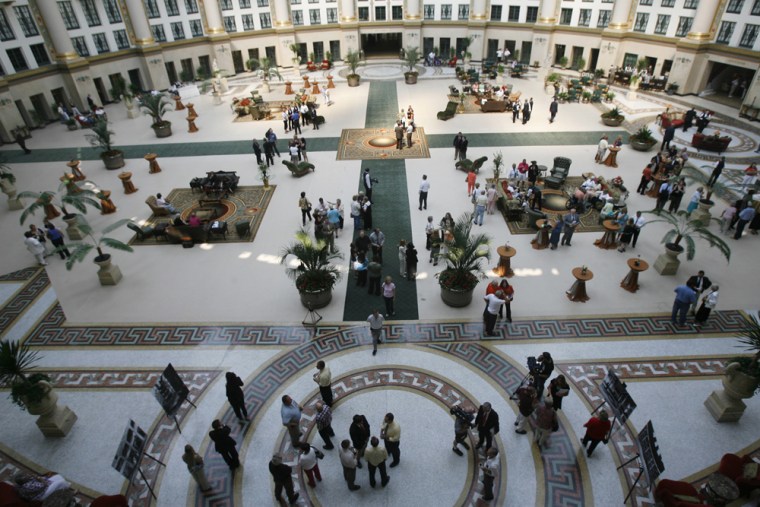 People gather in the atrium after the ribbon cutting ceremony to reopen West Baden Springs Hotel, a southern Indiana landmark that drew the famous and infamous before closing its guest register 75 years ago, in West Baden Springs, Ind., Wednesday, May 23, 2007. The hotel formally reopened Wednesday as a refurbished resort eager to draw gamblers and other visitors. Following a ribbon-cutting ceremony that capped a $90 million, nearly two-year restoration, the first guest to check in was Betty Oakley, the daughter of a former hotel gardener. (AP Photo/Indianapolis Star, Joe Vitti)