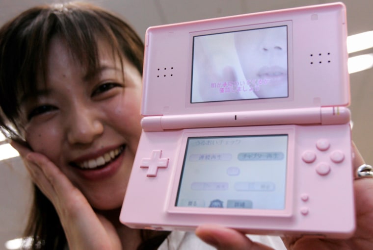 Konami Digital Entertainment Co's designer Nishimura poses with Dream Skincare software for Nintendo DS in Tokyo