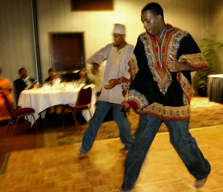 Mark Turner II, left, and Kevin J. Wyatt, Jr., perform a ceremonial dance marking the rite of passage from boyhood to manhood during Phi Beta Sigma's 6th annual Scholarship Beautillion on June 10, in Richmond, Va.