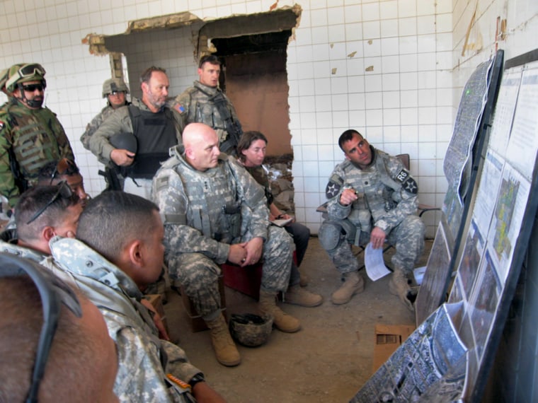 Lt. Gen. Raymond Odierno, center, is briefed by a field commander at a bombed-out hospital in Baqouba, Iraq, on Thursday.