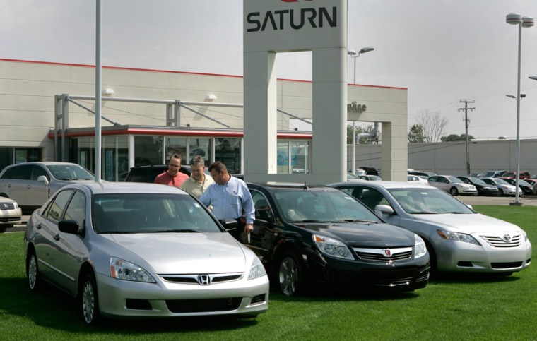Vince Olsen, center, the manager of a Saturn dealership in Troy, Mich., compares a Honda Accord, left, with a Saturn Aura, center, and a Toyota Camry as part of a promotion to boost Aura sales.