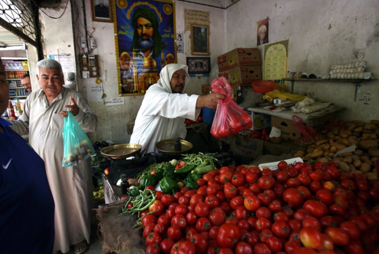 Iraqis shop at a market in central Baghdad on June 17. Officials say civilian deaths in Iraq were down 36 percent in June, raising hopes that a security crackdown in the capital is stanching sectarian bloodshed.