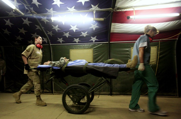 Air Force medics from the 332nd Expeditionary Medical Group rush a wounded soldier to the emergency room at the Air Force Theater Hospital at Balad Air Base, 50 miles north of Baghdad, Iraq, on Thursday. 