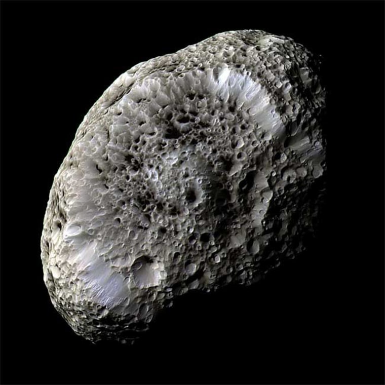 This view of Hyperion, captured during the Cassini spacecraft's flyby in September 2005, reveals details of the moon's spongy surface. The picture is a combination of images taken using infrared, green and ultraviolet spectral filters.