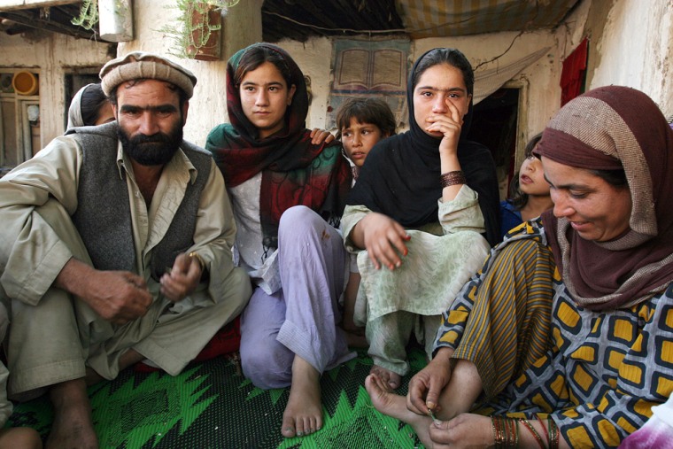 From left to right Malias father, sister, Malia, and her mother, during an interview with Associated Press in their home in Jalalabad, Afghanistan, Sunday, July 1, 2007. Unable to scrounge together $165 (120) to pay for the sheep he borrowed, Nazir Ahmad said he was forced instead to pay with his teenage daughter, Malia, now the fiancee of the lender's 18-year-old son.  (AP Photo/Farzana Wahidy)