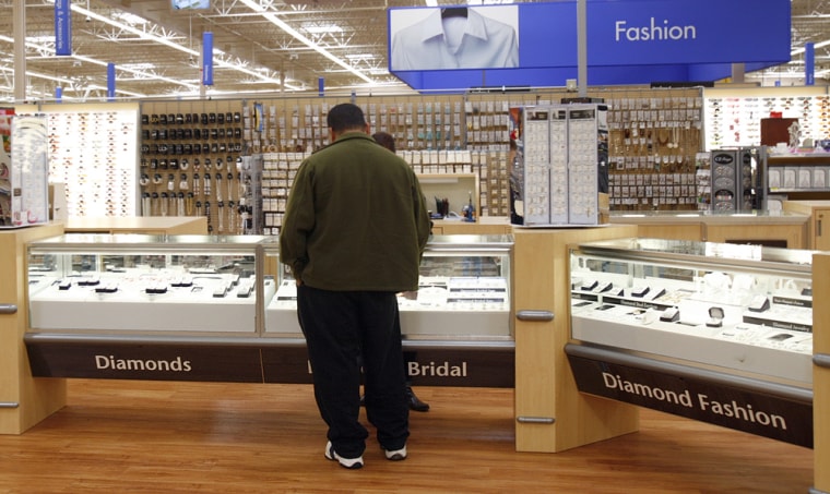 A customer looks at jewelry at a Wal-Mart in Federal Way, Wash. The average overall cost of an engagement ring is about $5,355.
