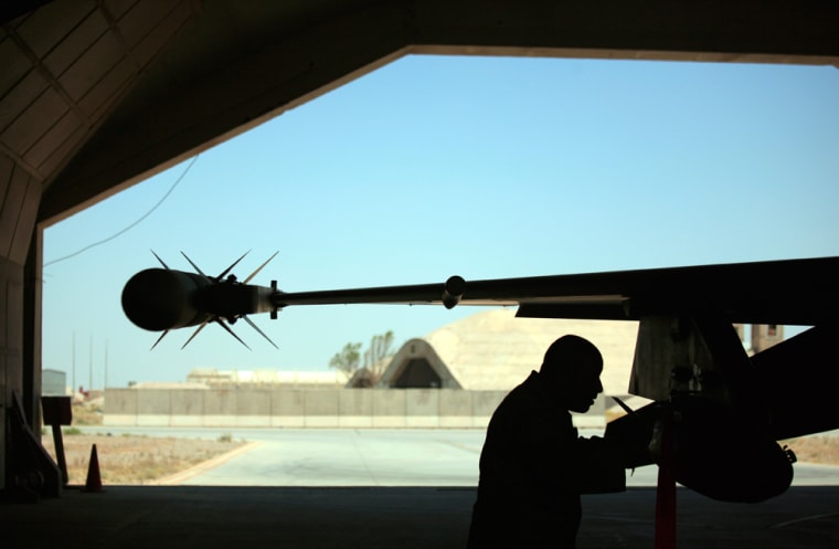 An aircraft maintenance technician makes final checks on an F-16 Falcon before flight at Balad Air Base, 50 miles north of Baghdad, Iraq Thursday, June 21, 2007.  (AP Photo/ Maya Alleruzzo)
