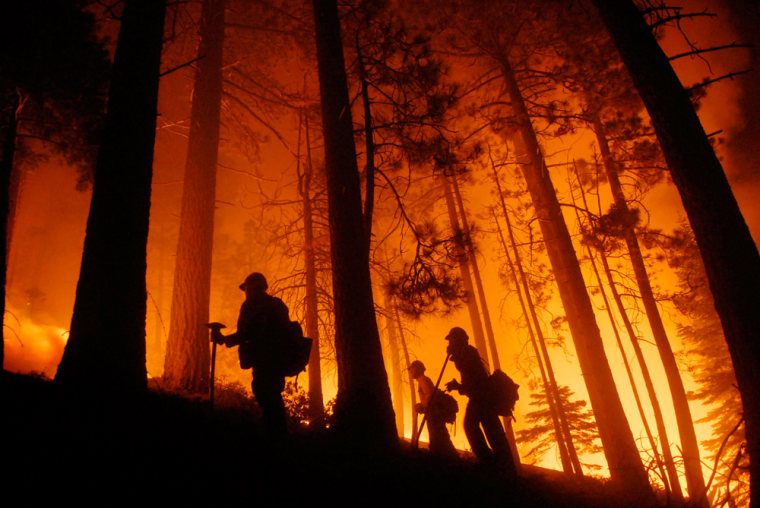 Firefighters keep watch on a prescribed burn set to fight a wildfire in South Lake Tahoe, Calif., on June 24