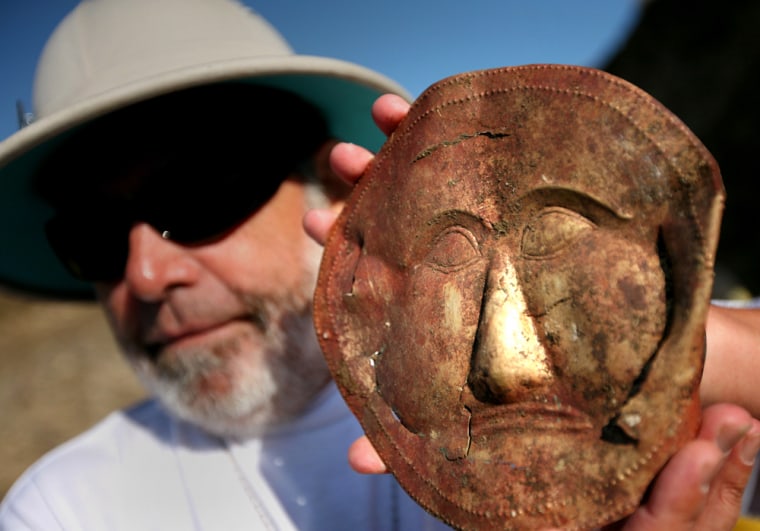 Bulgarian archaeologist Georgi Kitov on Sunday shows an ancient Thracian gold mask at a tomb near the village of Topolchane, east of the Bulgarian capital Sofia.