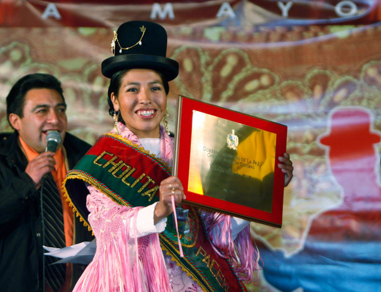 Mariela Molinedo, winner of the Miss Cholita Pacena 2007 pageant, holds up her winner's plaque in La Paz
