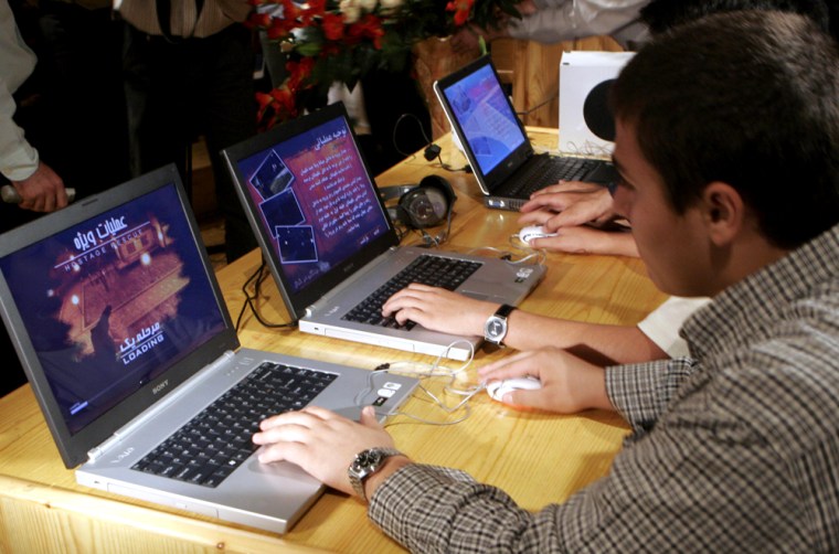 Iranian teenagers play the first Iranian made Nuclear Energy computer game "The Special Operation" in Tehran Monday. 