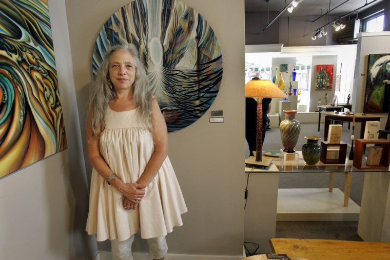 Owner Suzanne Corsano stands in her Gallery of the Woods shop on Main Street in Brattleboro. On July 6, she encountered a 68-year-old naked man as she was locking up for the night.