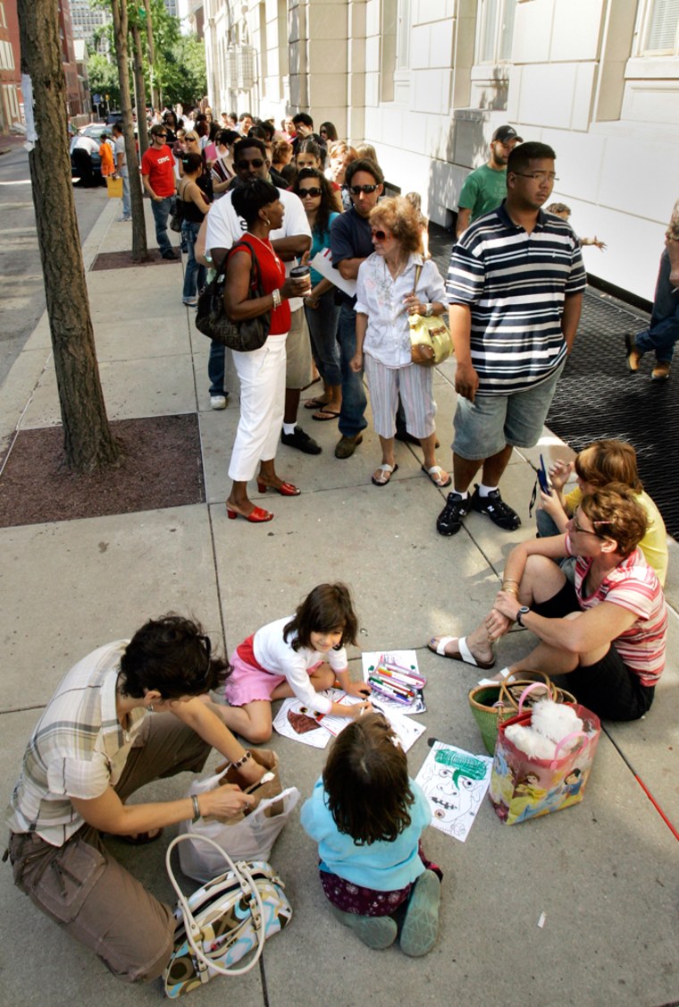 People wait in line outside a U.S. passport office in Philadelphia. Officials have scaled back new security rules in response to complaints as the waiting time for passports soared from around six weeks to more than three months, delaying or ruining the travel plans of thousands of Americans. 
