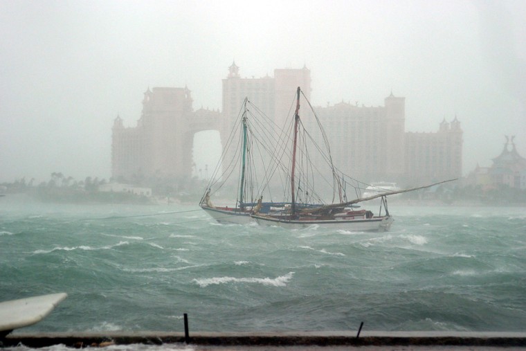 Haitian sloops rock around in rough seas in front of the Atlantis Paradise Island resort Friday, Sept. 3, 2004 as Hurricane Frances passes close to the island of New Providence in the Bahamas. A group of Haitians were forced to flee their sailing vessel in the harbor and take refuge on land after encountering problems on the boat. (AP Photo/Tim Aylen)