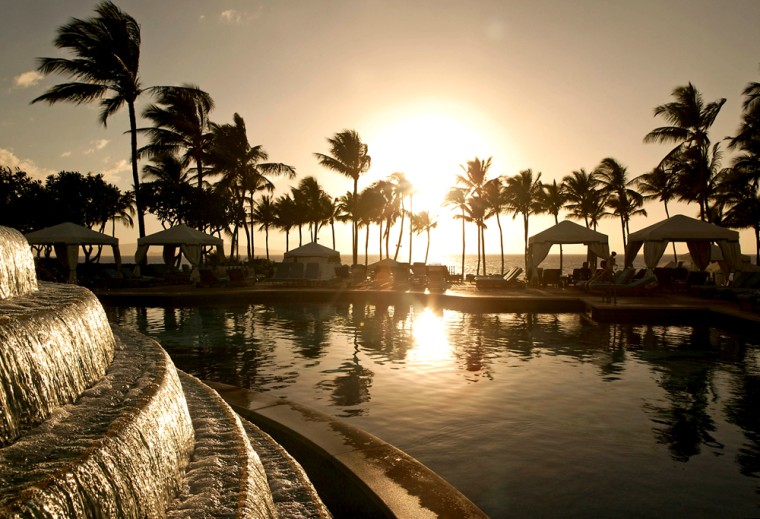 The sun sets poolside at the Grand Wailea Resort, in Wailea, Maui, Hawaii. Even your most blase child, the one who never gets impressed with anything, will produce an "awesome" upon registering at the Grand Wailea.
